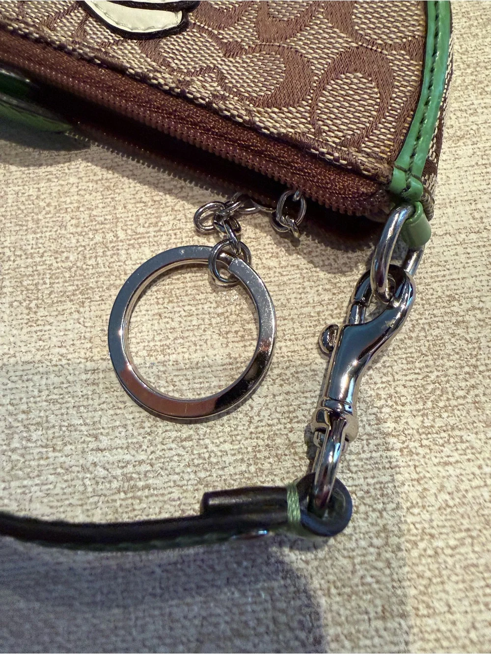 Coach Brown Signature Wristlet with Green Trim and Daisy Motif
